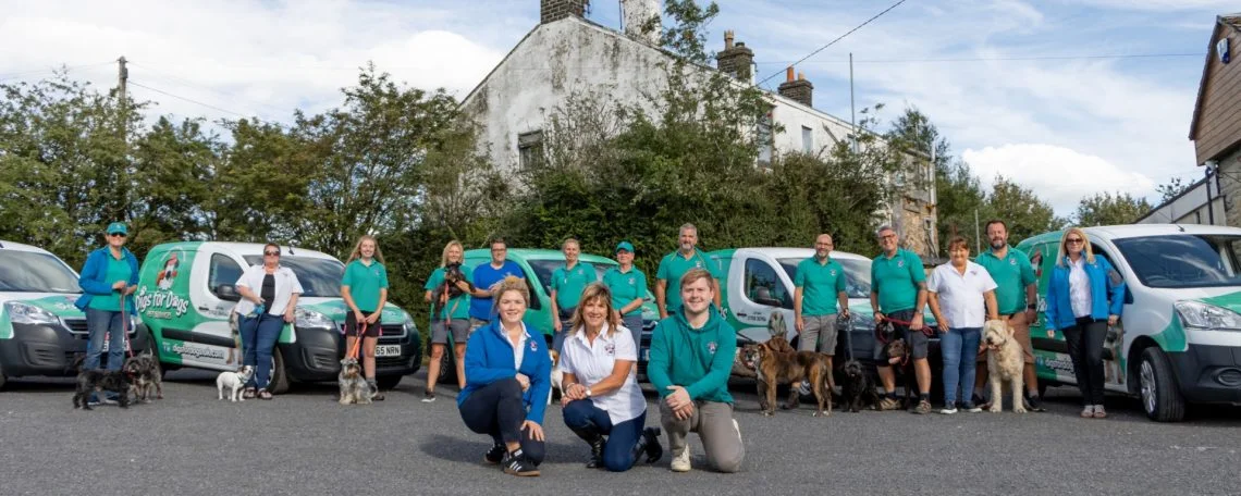 people in front of dog vans