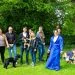 Dog trainer with dog owners and dogs in a field