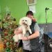 Woman with dog in front of Christmas tree