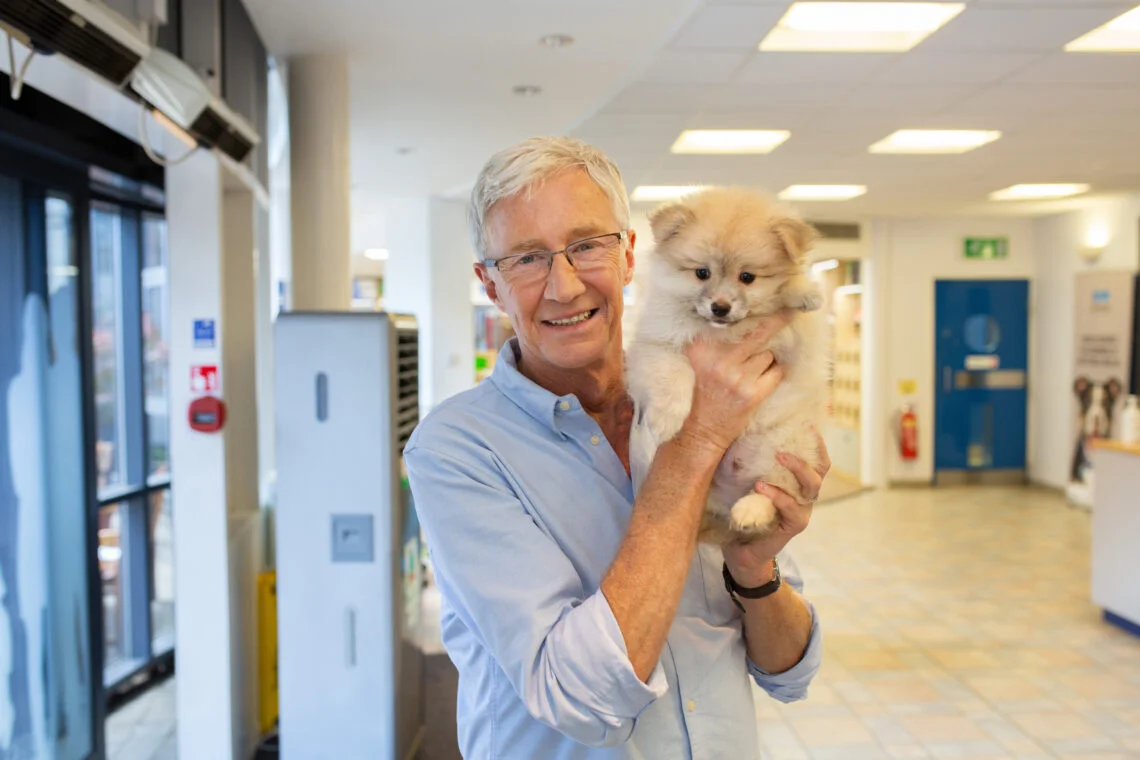 Paul O'Grady holding a dog