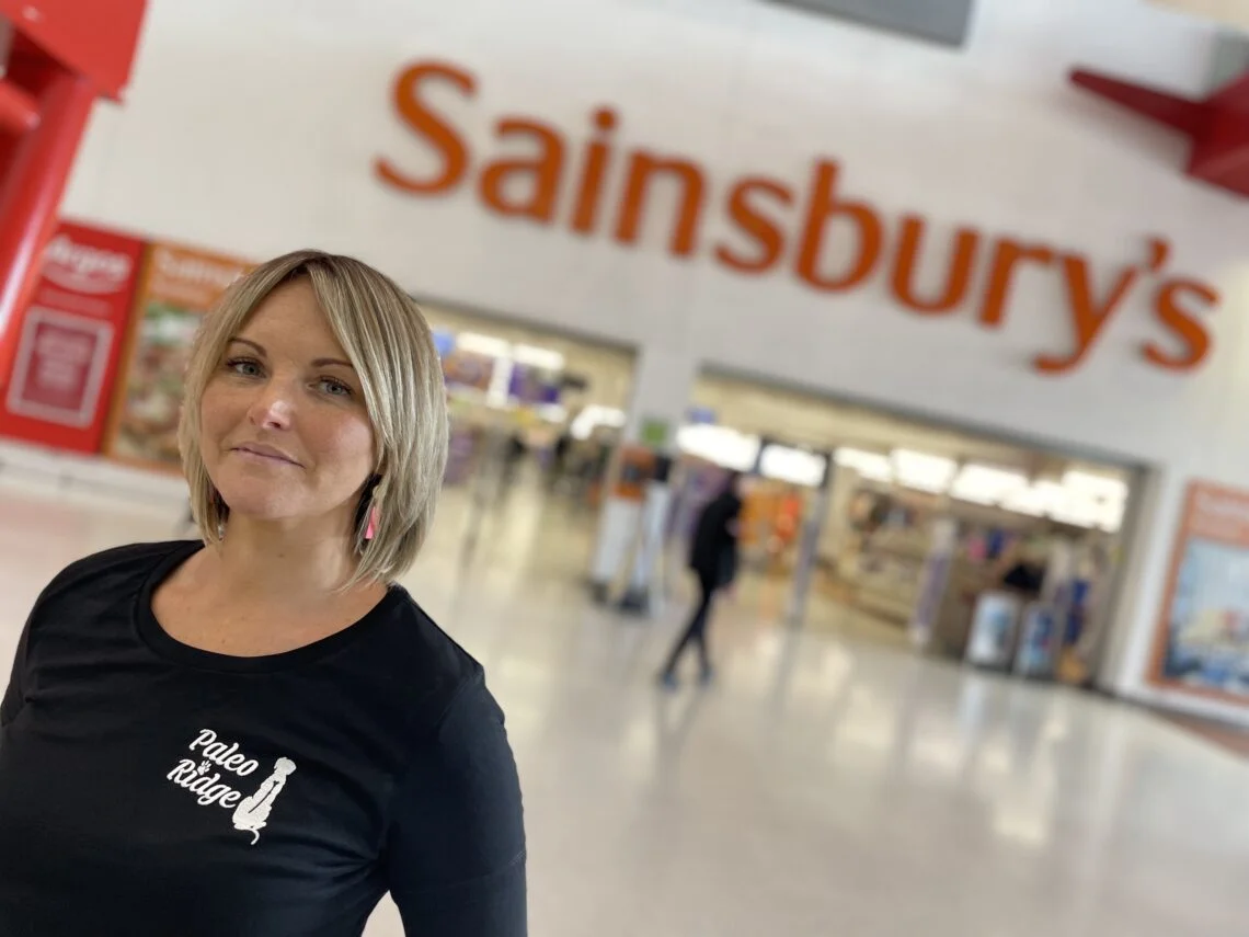 Woman in front of Sainsburys